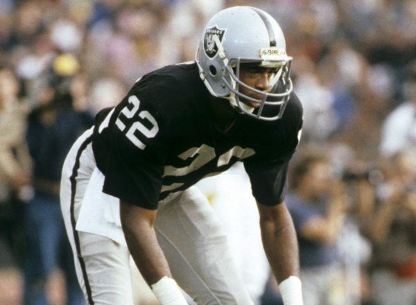 Defensive back Lester Hayes of the Oakland Raiders guards Carlos